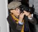 Inès de la Fressange, photographe en plein action lors du défilé haute couture de Christian Dior. Paris, le 23 janvier 2012.