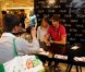 Camille Lacourt pose en compagnie de ses fans aux Galeries Lafayette, à Paris, samedi 1er septembre 2012.