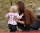 Kate Middleton, duchesse de Cambridge, assiste avec son chien Lupo à un match caritatif de polo auquel les princes William et Harry participent, à Westonbirt, le 17 juin 2012. Ici avec la petite Savannah, fille de Peter et Autumn Phillips