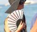 Sous son chapeau noire et éventail à la main, Paris Hilton se promène sur la plage de Pampelonne, à St-Tropez, le samedi 28 juillet 2012.