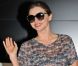 Miranda Kerr souriante à son arrivée à l'aéroport international de Narita. Tokyo, le 7 septembre 2012.