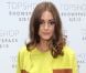 Olivia Palermo, habillée d'une veste et d'un top Simonetta Ravizza, d'un pantalon Topshop, d'une pochette Reiss et de chaussures Manolo Blahnik lors du défilé Unique printemps-été 2013. Londres, le 16 septembre 2012.