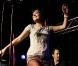 Sur scène, Lily Allen garde sa bonne humeur. Collants résille et mini short, la chanteuse montre ses nouvelles formes.  