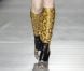 Miuccia Prada et sa maison de couture éponyme ont choisi pour leur collection Automne-Hiver 2011 de reprendre le python pour des bottes colorées. Milan, le 25 février 2011. 