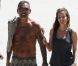Christian Audigier et sa belle Nathalie Sorensen sortent de la plage à Miami le 24 mars 2012