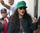 Rihanna, habillée d'un minishort et de bottines Chloë Sevigny pour Opening Ceremony et d'un pull Kenzo, une casquette de la même marque sur la tête, sort de son hôtel londonien. Le 28 août 2012.