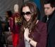 Victoria Beckham porte une robe Roland Mouret avec un cardigan bordeaux, des lunettes, une pochette et une ceinture Victoria Beckham et des souliers Christian Louboutin. New York, le 14 février 2012.