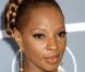 Mary J. Blige les cheveux tirés avec sa grosse natte sur le haut de la tête 