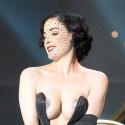 Dita Von Teese, prête à jouer de ses charmes pour... flinguer l'Eurovision ! Regardez : elle a déjà commencé à se déshabiller !