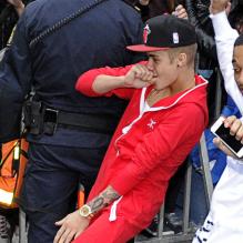 Justin Bieber, étrangement enjoué, sort de son hôtel en dansant avec un ami pour se rendre à son concert à Stockholm, le 24 avril 2013.