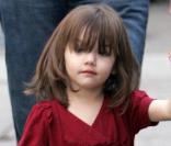 Suri Cruise dans une longue robe rouge imite déjà les grands 