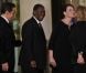 Carla Bruni-Sarkozy et Nicolas Sarkozy posent devant le seuil du palais présidentiel de l'Elysée avec Alassane  Ouattara, président ivoirien, et son épouse Dominique Ouattara, le 26 janvier 2012, à l'occasion d'un dîner d'Etat 
