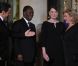 Carla Bruni-Sarkozy et Nicolas Sarkozy posent devant le seuil du palais présidentiel de l'Elysée avec Alassane  Ouattara, président ivoirien, et son épouse Dominique Ouattara, le 26 janvier 2012, à l'occasion d'un dîner d'Etat 