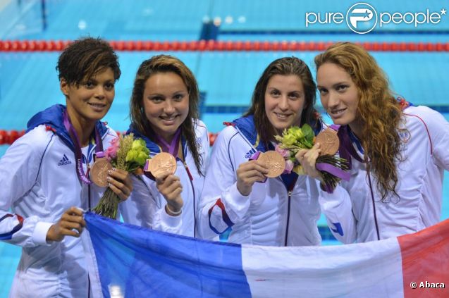 Camille Muffat, Charlotte Bonnet, Ophelie-Cyrielle Etienne et Coralie Balmy heureuses après avoir décroché le bronze olympique lors du relais 4x200 m nage libre lors des Jeux olympiques de Londres le 1er août 2012