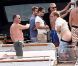 Elton John, entouré d'amis sur un yacht, montre ses fesses aux photographes au large de St-Tropez, le lundi 13 août 2012.