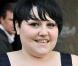 Beth Ditto à Paris au défilé Stella McCartney avec sa robe Hervé Léger 