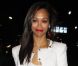 Zoe Saldana arrive au défilé Kohl's Rock & Republic avec un jean de la marque, une veste et un top blanc, une pochette Valentino et des talons Casadei. New York, le 10 février 2012.