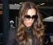 Victoria Beckham porte une robe noire, une ceinture et une pochette Victoria Beckham et chaussures Daffodile signées Christian Louboutin. New York, le 15 février 2012.