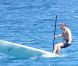 L'ancien ministre Eric Besson se laisse tenter par le paddle surfing au large de Saint-Tropez, le 12 juillet 2012.