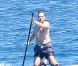 L'ancien ministre Eric Besson se laisse tenter par le paddle surfing au large de Saint-Tropez, le 12 juillet 2012.