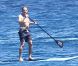 L'ancien ministre Eric Besson se laisse tenter par le paddle surfing au large de Saint-Tropez, le 12 juillet 2012.