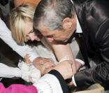 Johnny et Laeticia Hallyday avec au cours du baptême de Joy à Gstaad en Suisse le 5 juillet 2009 : ici avec le parrain Jean-Claude Darmon et la marraine Hélène Darroze 