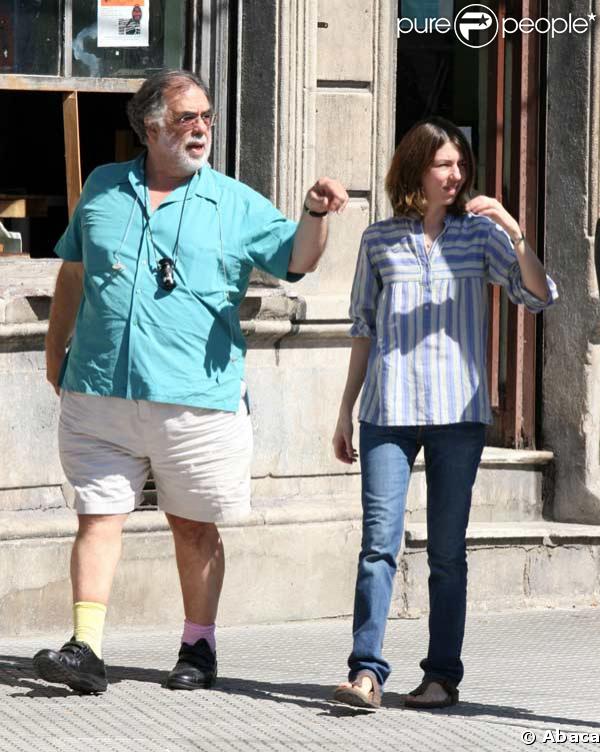 Sofia Coppola in a denim skirt and white sweater and white Birkin