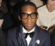 Le rappeur Tinie Tempah était sur son 31 au premier rang du défilé Lanvin automne-hiver 2012/2013 Paris, le 22 janvier 2012.