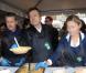 Antoine de Caunes, Anne-Sophie Lapix et Thierry Ardisson participent au service du curry géant cuisiné avec des légumes destinés à être jetés, pour dénoncer le gaspillage alimentaire, à Paris, le samedi 13 octobre 2012.