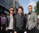 Le groupe avec Muse Matt Bellamy en son centre, Christopher Wolstenholme à droite et Dominic Howard à gauche, lors de la première mondiale de World War Z, à l'Empire Leicester Square, Londres, le 2 juin 2013.