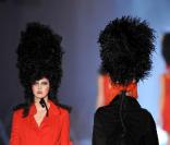Défilé printemps-été 2009 de John Galliano, deux top traversent le podium dans des tenues rouges et noires so british. 