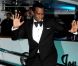P. Diddy, élégant dans un smoking noir, fait le show devant les photographes présents devant le yacht de Denish Rich. Cannes, le 18 mai 2012.