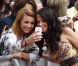 Tulisa Contostavlos est sollicitée par ses fans à son arrivée à la première audition de la neuvième saison de l'émission  X Factor , à Liverpool le 23 mai 2012.