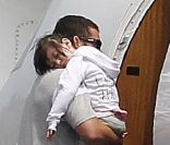 Adam Sandler porte sa petite Sunny dans les bras alors qu'il prend l'avion avec sa femme Jacqueline Titone et leurs deux filles Sunny et Sadie à l'aéroport de Burbank le 4 juin 2011
