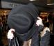 A la sortie d'une défilé de mode, Lindsay Lohan se rend à l'aéroport de Milan et ne peut s'empêcher de s'en prendre aux paparazzi présents en leur jetant une canette de RedBull le 1er mars 2010
