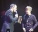 Justin Bieber reçoit le NRJ Music Award de la Révélation internationale de l'année des mains de Nikos Aliagas, lors de sa venue au Grand Rex (Paris), le jeudi 17 février.