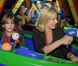 Laurence Ferrari et un enfant en pleine attraction Buzz l'Éclair, à Disneyland Paris. Elle était présente pour faire partager un moment de bonheur aux enfants de l'association SOS villages d'enfants le dimanche 12 juin 2011 !