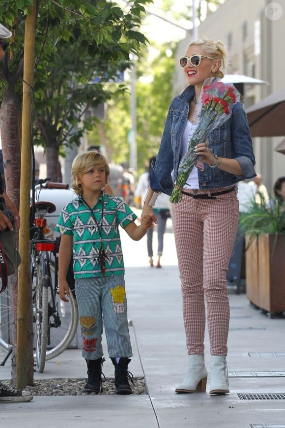 Gwen Stefani accompagnée de son fils Kingston, souriante après avoir reçu un bouquet de roses d'un paparazzi. Los Angeles, le 13 mai 2012.
