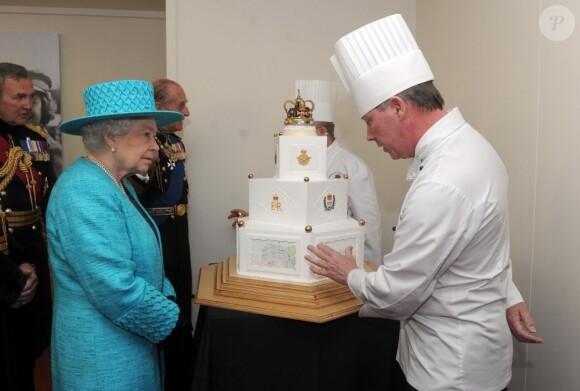 Découverte d'un gâteau spécial jubilé, après le défilé.
La reine Elizabeth II, avec son époux le duc d'Edimbourg, des membres de sa famille et ses invités de marque, assistait le 19 mai 2012 à Windsor à la grande parade des forces armées britanniques donnée en l'honneur de son jubilé de diamant.