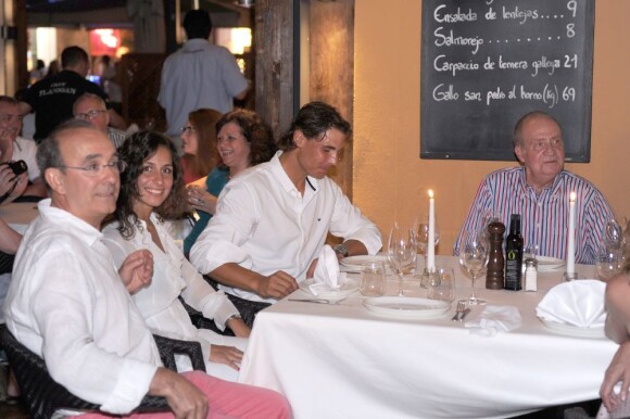 Le roi Juan Carlos voulait témoigner son amitié et remonter le moral de son champion... Rafael Nadal, avec sa compagne Xisca Perello, était l'invité du roi Juan Carlos Ier d'Espagne le 10 août 2012 au restaurant Flanigan, à Majorque.