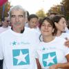 Raymond Domenech et Estelle Denis lors de la 10e édition de de la course Odyssea au profit de de la lutte contre le cancer du sein au château de Vincennes le 7 Octobre 2012
