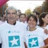 Raymond Domenech et Estelle Denis lors de la 10e édition de de la course Odyssea au profit de de la lutte contre le cancer du sein au château de Vincennes le 7 Octobre 2012