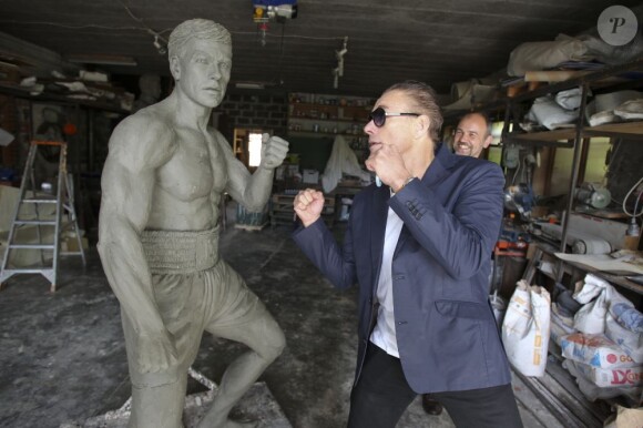 Jean-Claude Van Damme avec l'artiste Guy Ducheyne qui vient de signer une statue à l'effigie de l'acteur belge à Anderlecht, le 17 septembre 2012.