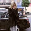 Kate Moss dans un look parfait composé de boots Isabel Marant et d'un jean léopard. Le 23 octobre à Londres