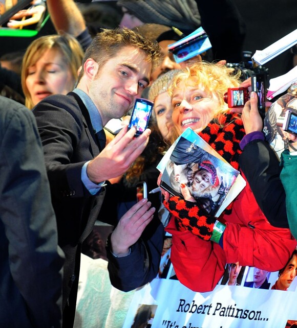 Robert Pattinson pose pour des photos avec les fans de la saga.