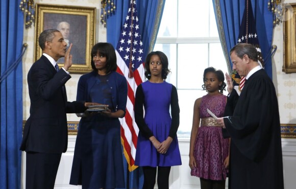 Barack Obama prête serment devant le juge de la Cour suprême John Roberts, accompagné par sa femme Michelle Obama, dans le Salon Bleu de la Maison-Blanche, à Washington, le 20 janvier 2013.