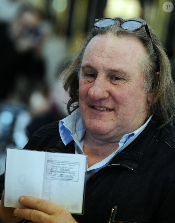 French actor Gerard Depardieu shows off his Russian passport as Mordovia's resident at the ceremony in the State Mordovia National Drama Theatre in Saransk, Russia on February 23, 2013. Depardieu has been granted permanent residence in Saransk. Photo by Stanislav Krasilnikov/Itar-Tass/ABACAPRESS.COM23/02/2013 - Saransk