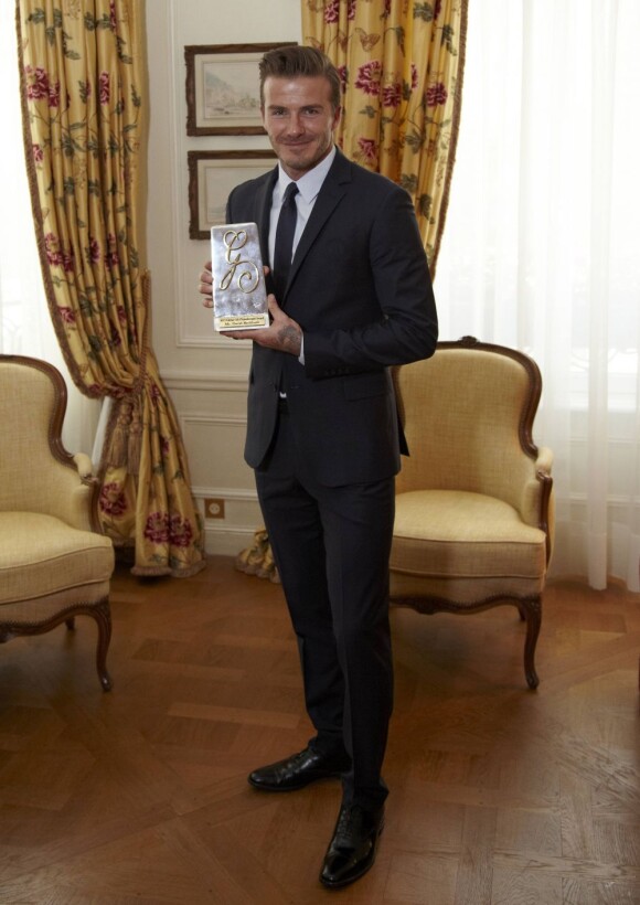 David Beckham avec son prix Philantropist décerné à l'occasion du Global Gift Gala qui se tenait au George V à Paris, le 13 mai 2013