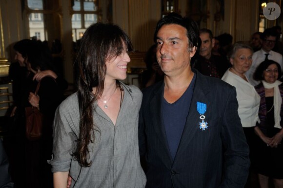 Yvan Attal pose avec Charlotte Gainsbourg, sa fiancée, après avoir reçu les insignes de chevalier de l'Ordre National du mérite au ministère de la Culture à Paris le 19 juin 2013