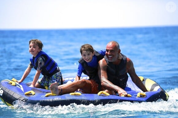 Exclusif - Christian Audigier en vacances avec ses trois enfants Rocco Mick Jagger, Dylan, et Vito à Ibiza le 7 juillet 2013.